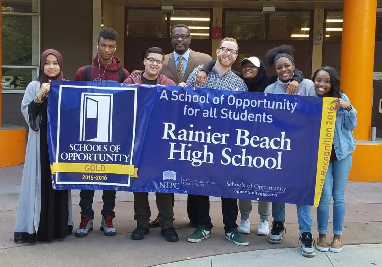 Students at Rainier High School holding a recognition banner