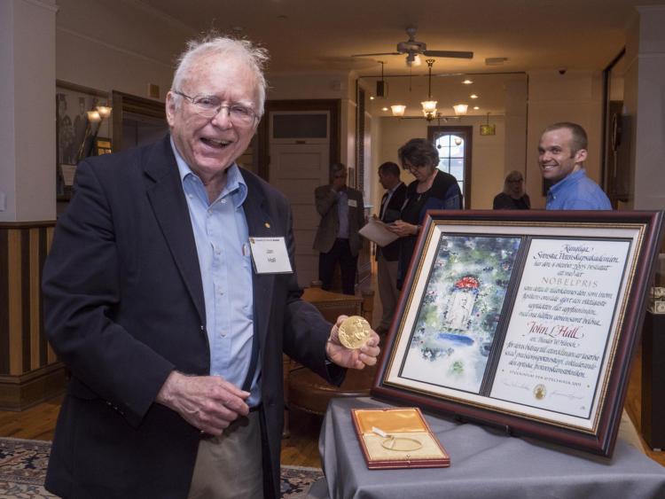 Jan Hall holds up his Nobel Prize medal