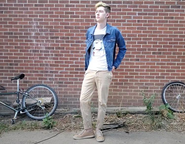 Jaret Anderson stands near a brick wall