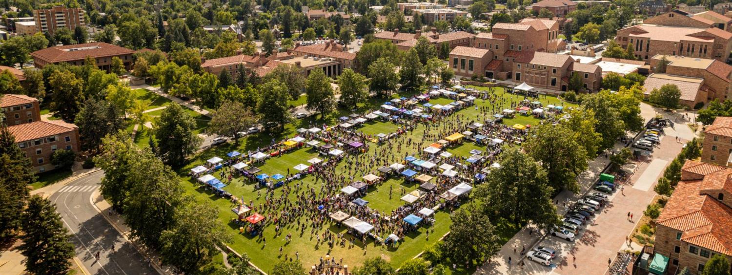 Tables and campus community members fill Farrand Field during the Be Involved Fair