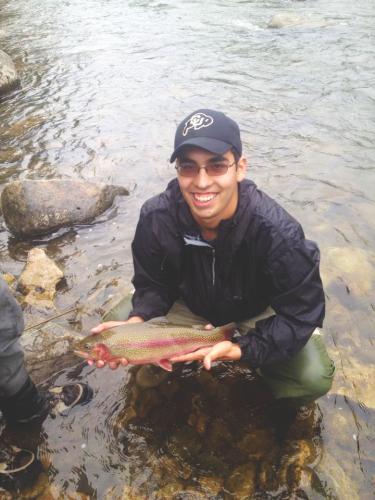 Engineering and jazz music student shows off trout caught while fly fishing