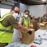 Stock image of workers packing food boxes during the COVID-19 pandemic