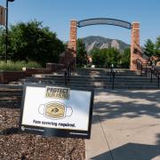 A Protect Our Herd–face covering required sign at the entrance of Farrand Field