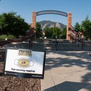 A Protect Our Herd–face covering required sign at the entrance of Farrand Field