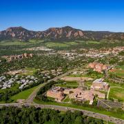 CU Boulder aerial campus view with foothills and mountains in the background.