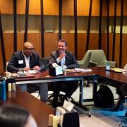 CU President Todd Saliman and Dean of Students J.B. Banks sit next to each other at a meeting table with others.