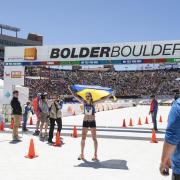 Participant celebrates end of race at Folsom Field