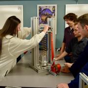 Students test the spring's strength in the Senior Design Lab