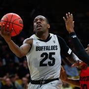 Colorado's McKinley Wright IV goes for a lay-up against a University of Dayton player