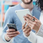 two people looking at devices