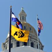 Colorado state capitol building with state, national and CU flags flying