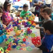 Children creating colorful paper sculptures