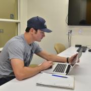 Student works on computer in Business Library