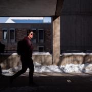 Student walking on a snowy campus