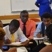 A group of students takes notes during the boys2MEN summit