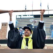 Jim Williams holds university mace, or staff, during 2017 commencement