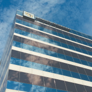 A CU building reflects clouds in the sky