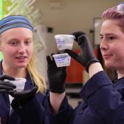 Researchers holding lab samples