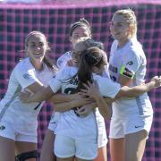 CU women's soccer team hug in celebration