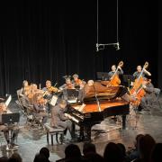 string musicians and pianist on stage