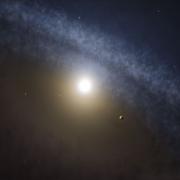 ring of dust around a star with small planet in the foreground