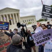 Anti-abortion protesters use bullhorns to counter abortion rights advocates outside the Supreme Court on May 3, 2022