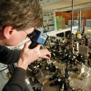 A research assistant at the the German National Metrology Institute studies an atomic clock