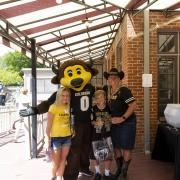 Chip the buffalo mascot with a family dressed in Buffs gear