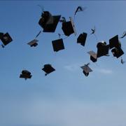 Graduation caps thrown up in the air