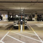 Car at EV charging station in parking garage