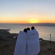 Friends enjoy the sunrise over the Dead Sea in Israel