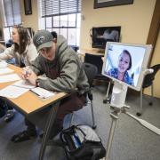 Students using a Kubi device for distance learning