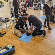 trainees practice CPR on dummies