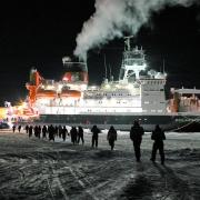 People walk across the ice  toward Polarstern. Photo by Michael Gutsche.