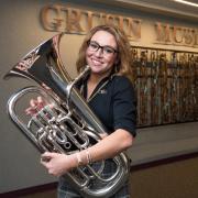 Nora Barpal poses with euphonium at Grusin Music Hall