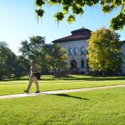 Campus community member walks across Norlin Quad