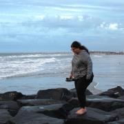 Emily Nocito walking on rocks along the Ocean City shore