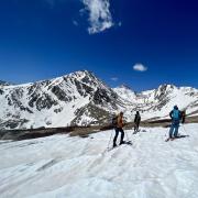 Researchers on skis collect snow measurements near the Continental Divide in Colorado