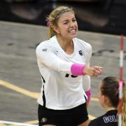 A CU volleyball player wears pink during a match