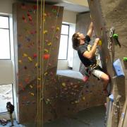 Jared Spegele picks a rout on the climbing wall at The Rec