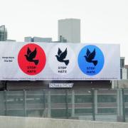 Billboard art displaying three circles with doves in them