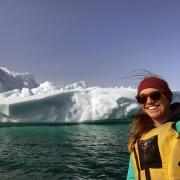 Sarah Crump poses in front of an Arctic glacier