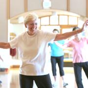 Senior woman exercising in group class