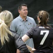 Soccer coach Danny Sanchez stands with a group of players