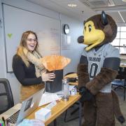 Chip the buffalo mascot gifting an employee