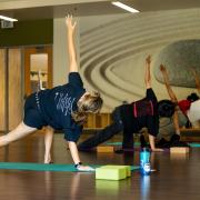 students participating in a yoga class on campus