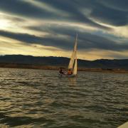 CU Boulder student sails at sunset on Colorado lake