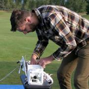 Graduate student Villiam Klein sets up 360-degree camera to be launched via balloon