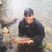 Engineering and jazz music student shows off trout caught while fly fishing