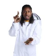 Samuel Ramsey, in a white lab coat, is covered with bees.